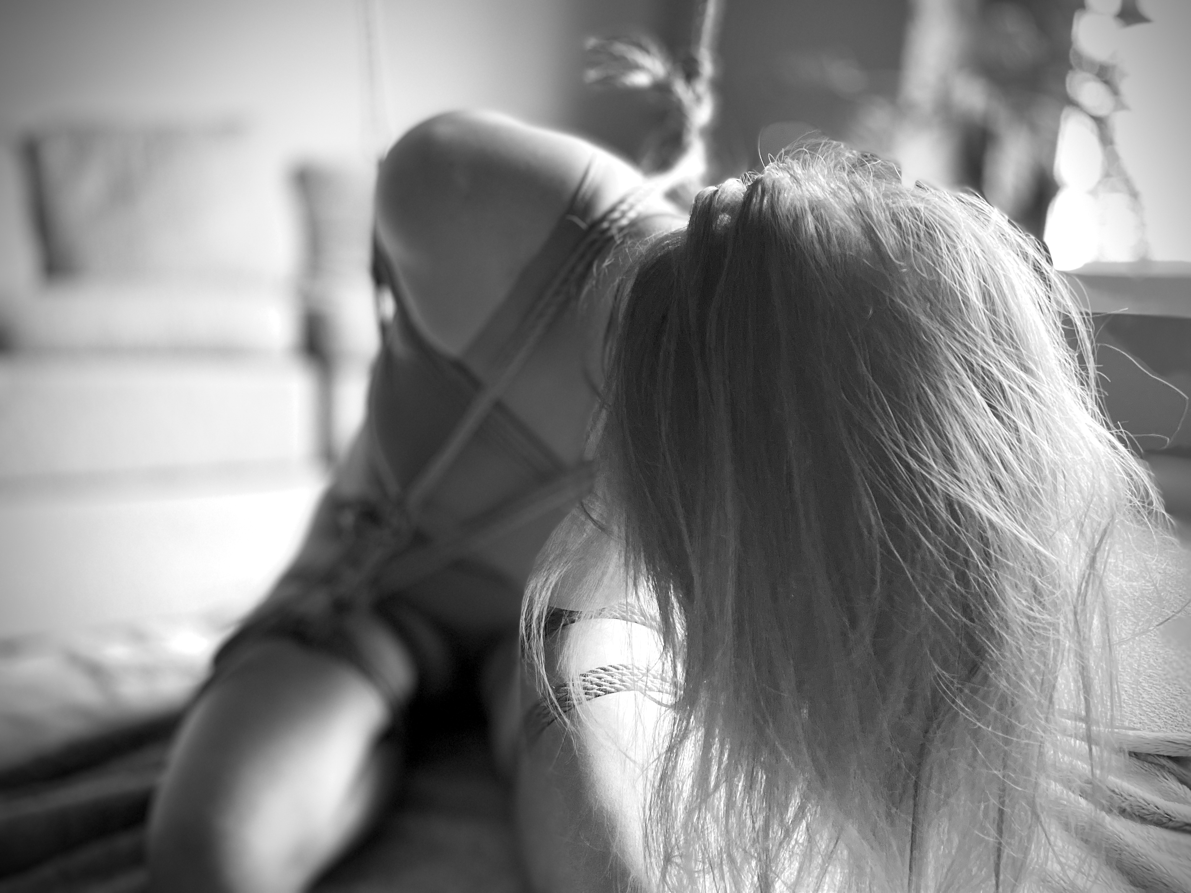 Black and White photo of a blonde woman in rope