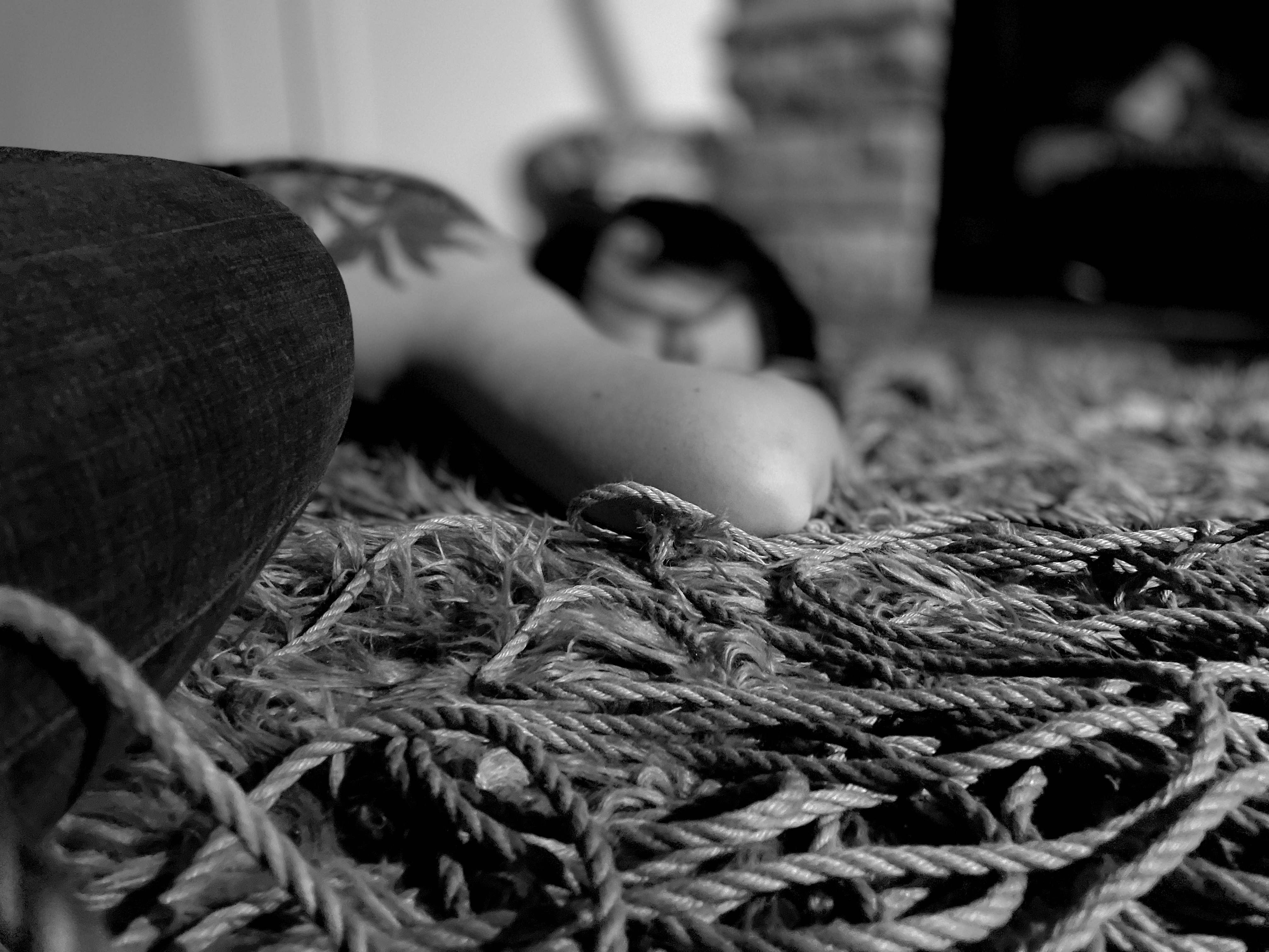 Shallow depth of field of a person laying relaxed on a pile of rope.